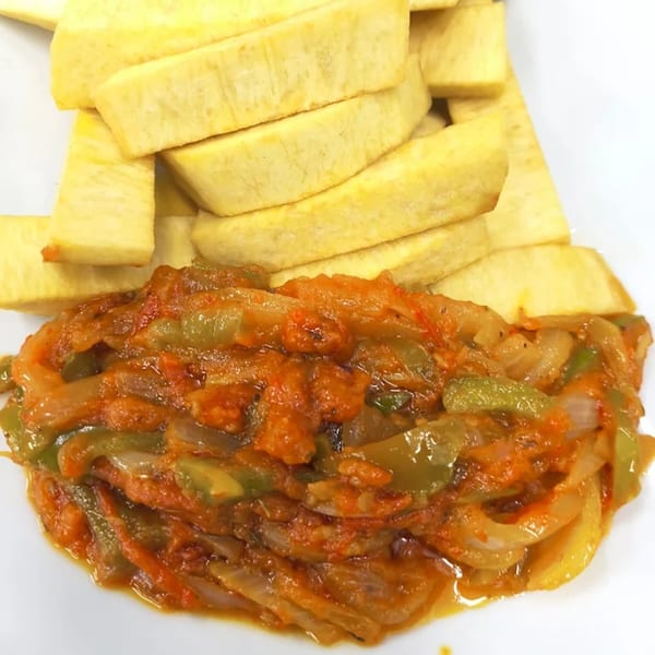 Fried yam slices with a side of tomato and pepper stew, a Nigerian dish from Arona Food Place.