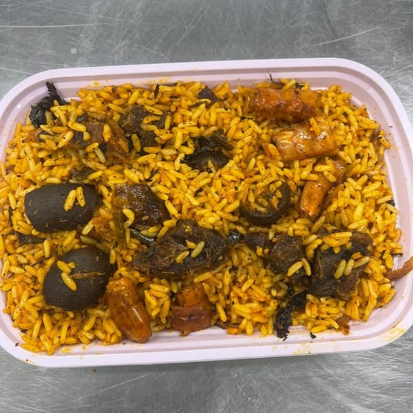 Arona Food Place's Nigerian jollof rice with meat, mushrooms, and plantains in a white container.